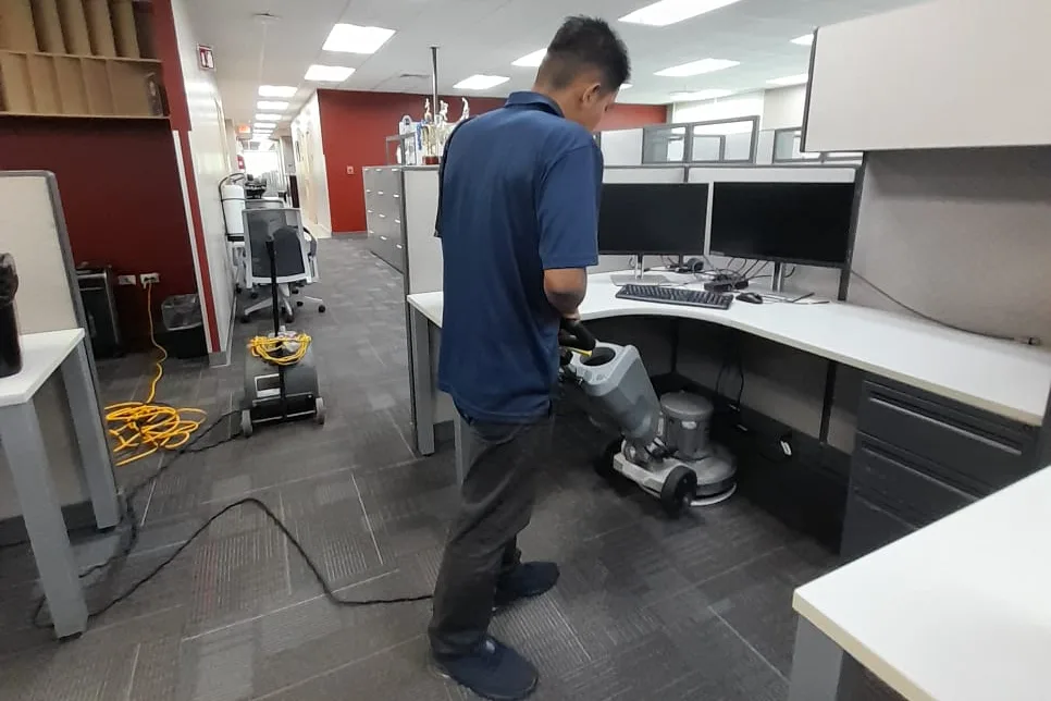 Operario de Go Services puliendo el piso de una oficina corporativa